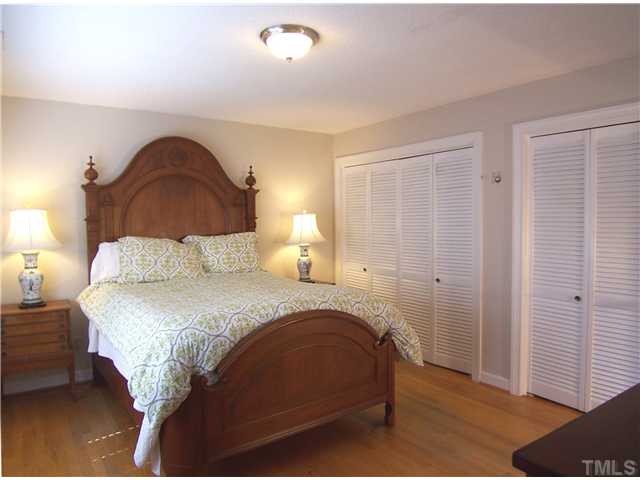 4920 Brookhurst Place Raleigh, NC 27609 - Photo 14 of 24 a bedroom with a bed and a night stand