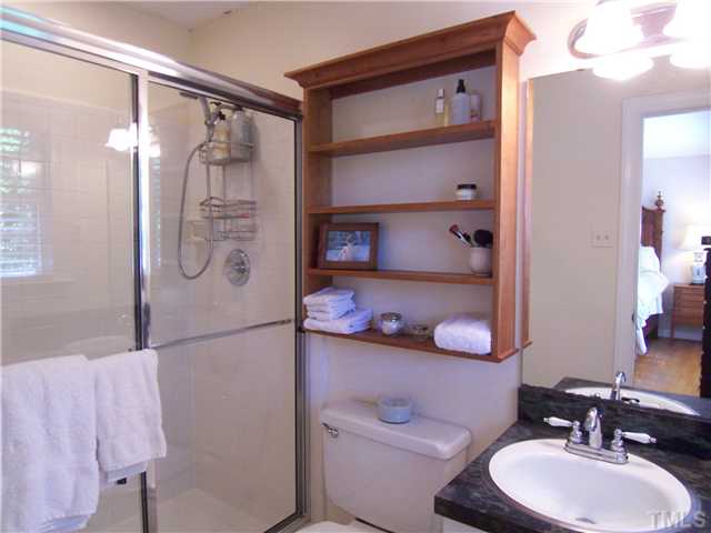 4920 Brookhurst Place Raleigh, NC 27609 - Photo 15 of 24 a bathroom with a sink toilet and shower