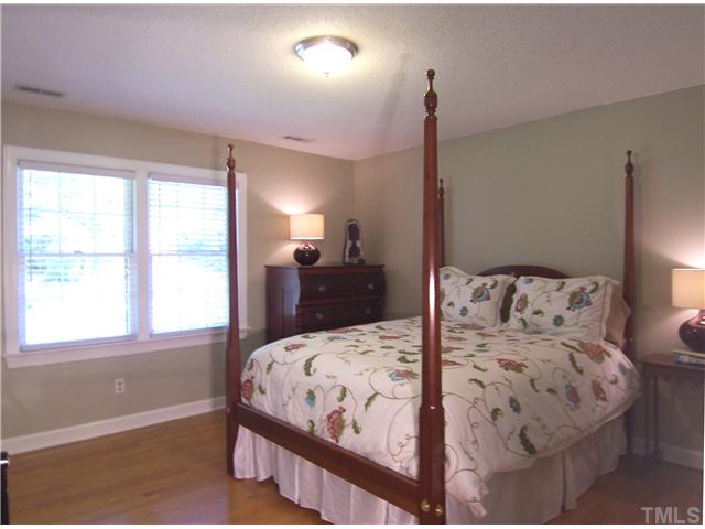 4920 Brookhurst Place Raleigh, NC 27609 - Photo 16 of 24 a bedroom with a large bed and a window