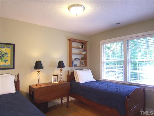 4920 Brookhurst Place Raleigh, NC 27609 - Photo 18 of 24 a bedroom with furniture and wooden floor