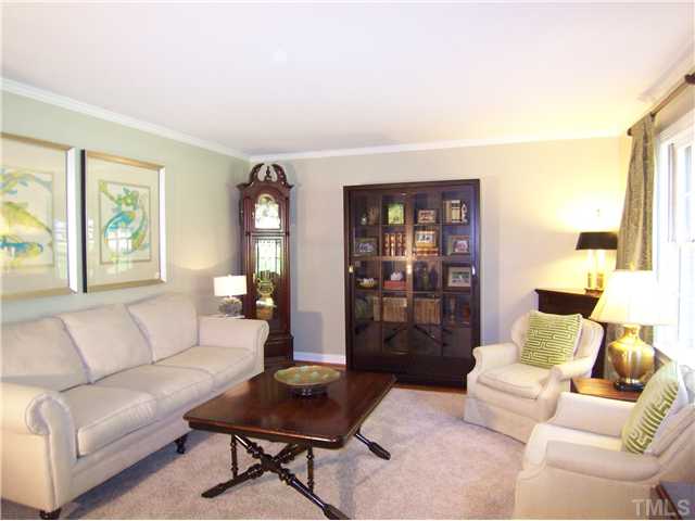 4920 Brookhurst Place Raleigh, NC 27609 - Photo 3 of 24 a living room with furniture and a lamp