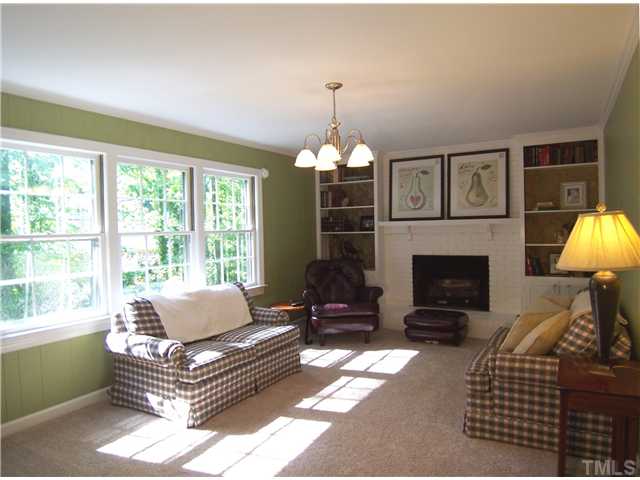 4920 Brookhurst Place Raleigh, NC 27609 - Photo 8 of 24 a living room with furniture a window and a fireplace