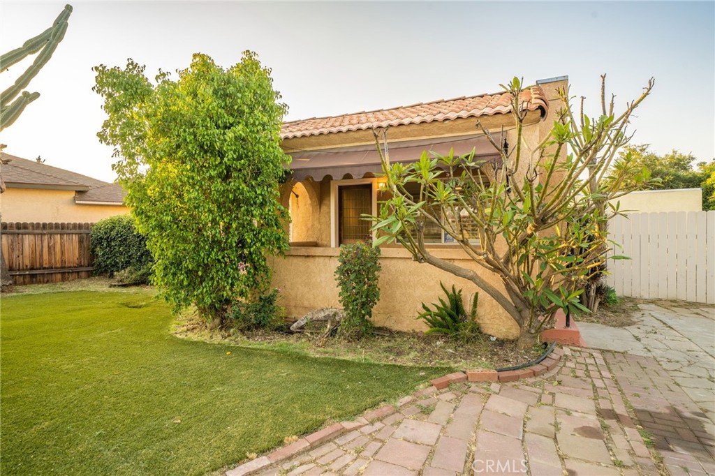 a view of a white house with a yard