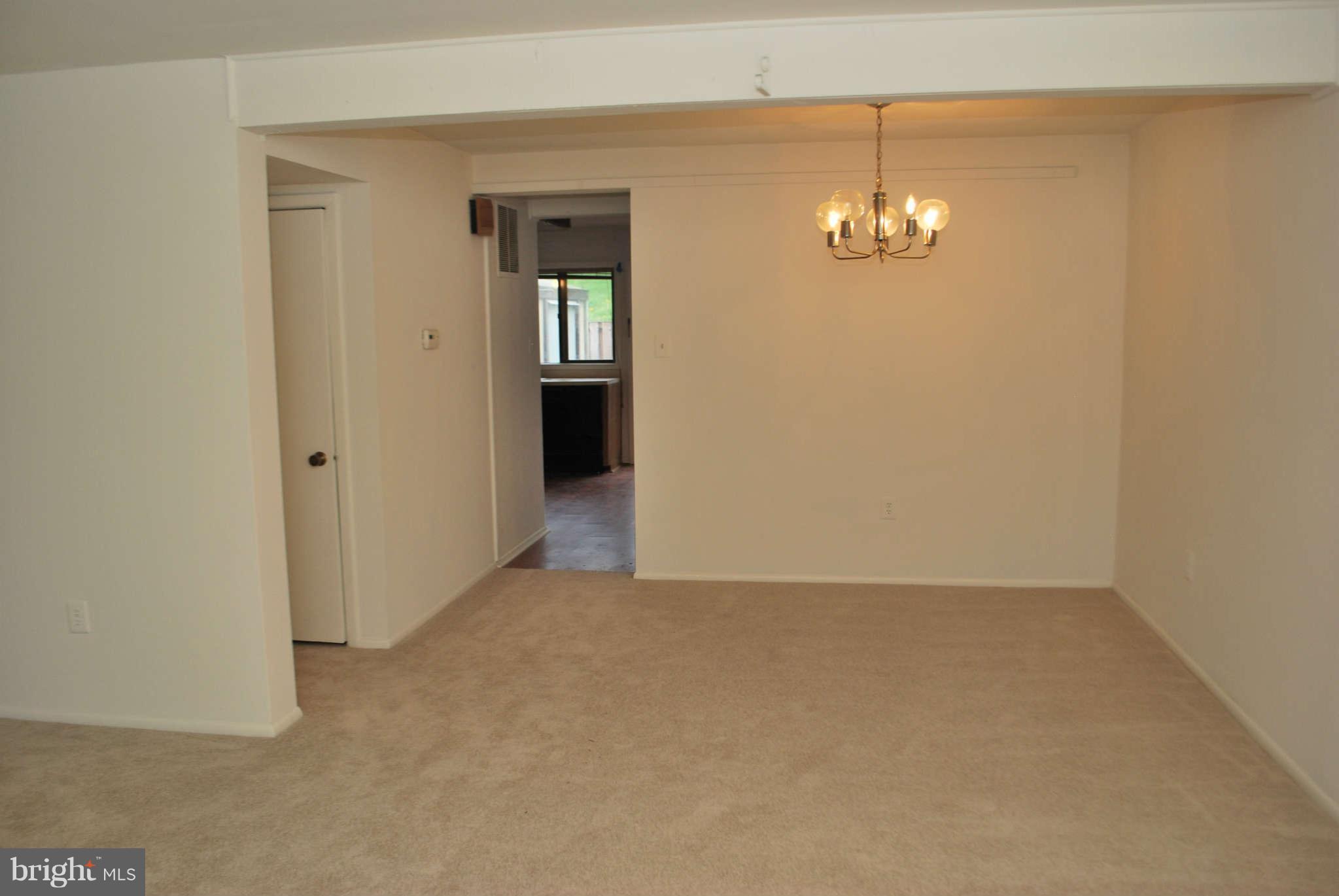 9116 Centerway Road Gaithersburg, MD 20879 - Photo 5 of 25 an empty room with chandelier fan