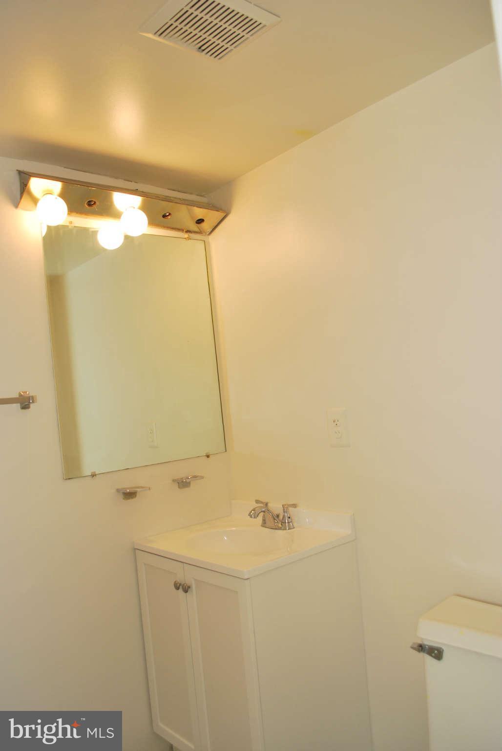 9116 Centerway Road Gaithersburg, MD 20879 - Photo 7 of 25 a bathroom with a sink and mirror