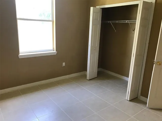 a view of an empty room with closet