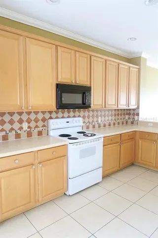 a kitchen with white cabinets sink and white appliances