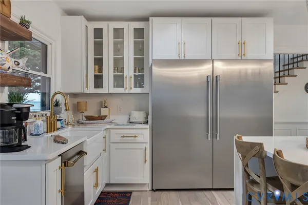 a kitchen with stainless steel appliances granite countertop a refrigerator and a stove top oven