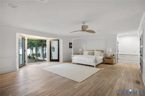 a bedroom with a large bed and a large window