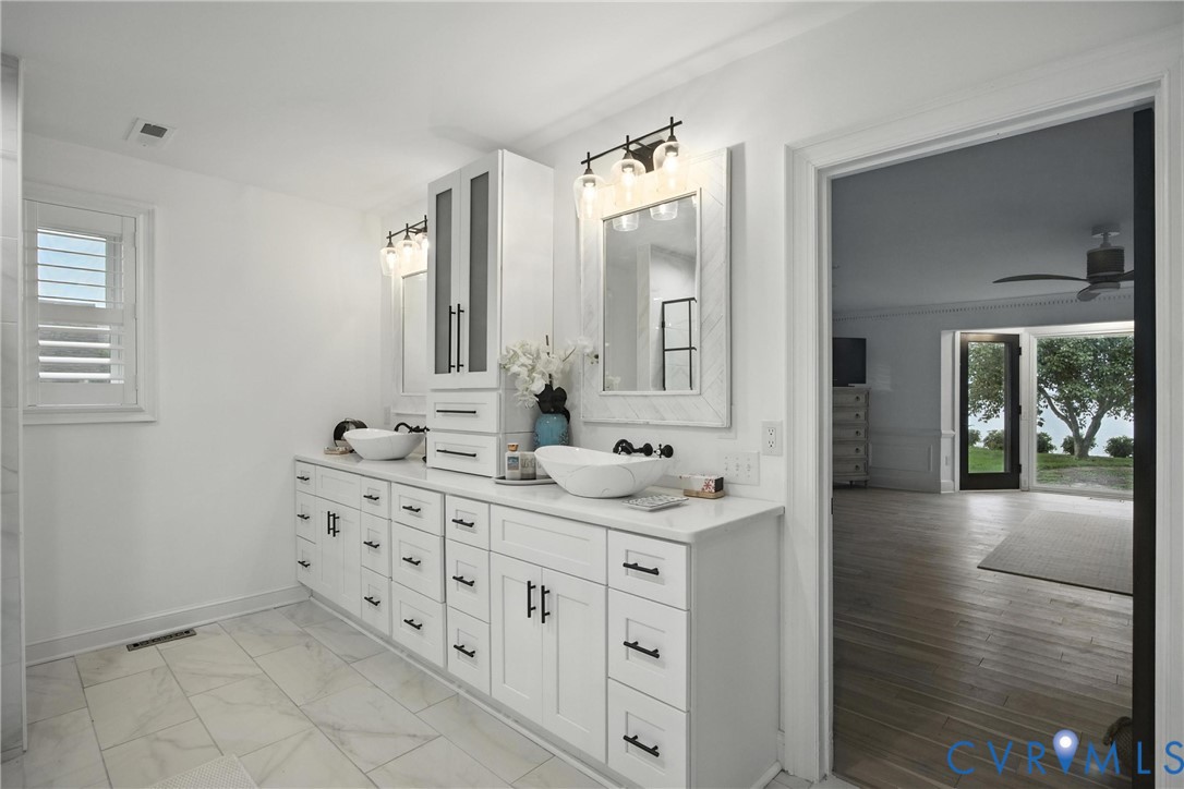 467 Daingerfield Road Tappahannock, VA 22560 - Photo 17 of 50 a spacious bathroom with a double vanity sink a mirror and next to a window