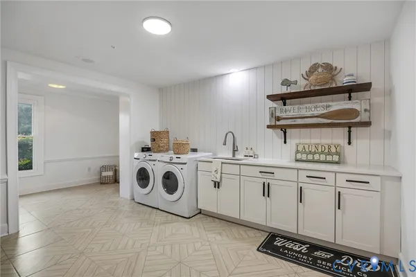 a utility room with sink dryer and washer