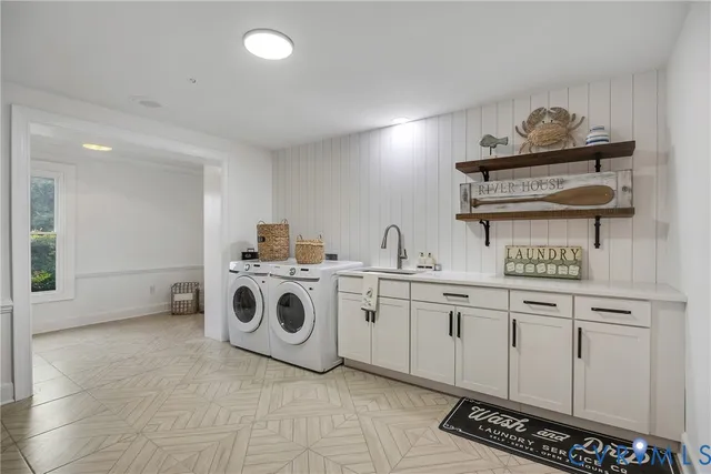 a utility room with sink dryer and washer