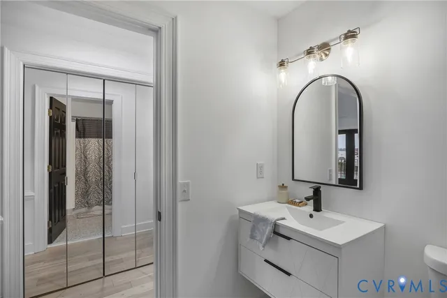 a bathroom with a toilet sink and mirror
