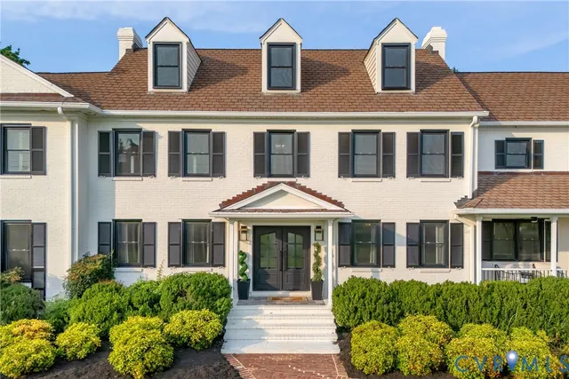 front view of a brick house with a large window