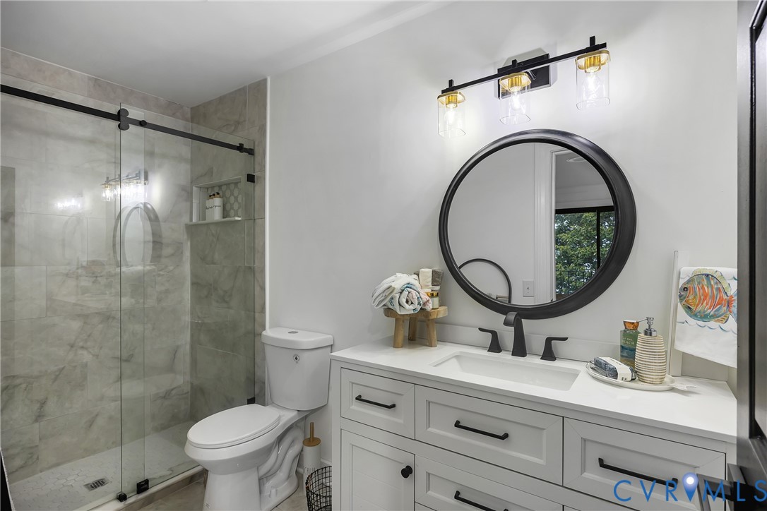 467 Daingerfield Road Tappahannock, VA 22560 - Photo 34 of 50 a bathroom with a sink mirror toilet and shower