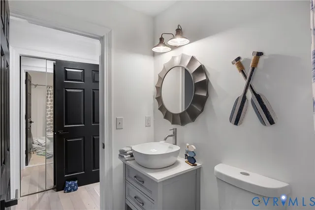 a bathroom with a toilet sink and mirror