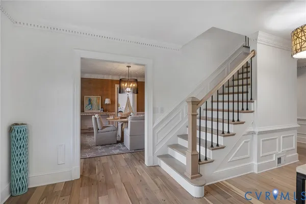 a view of entryway and hall with wooden floor