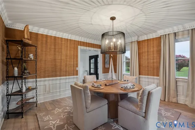a view of a dining room with furniture wooden floor and chandelier