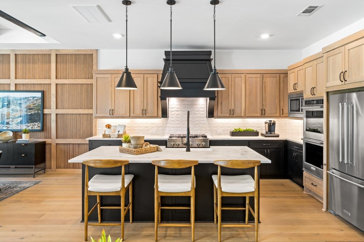 4807 Morning Spgs Drive Spring, TX 77386 - Photo 5 of 14 a kitchen with stainless steel appliances granite countertop a kitchen island a stove a table and chairs