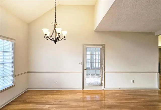 a view of a livingroom with wooden floor and a window