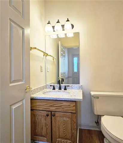 a bathroom with a sink vanity mirror and toilet