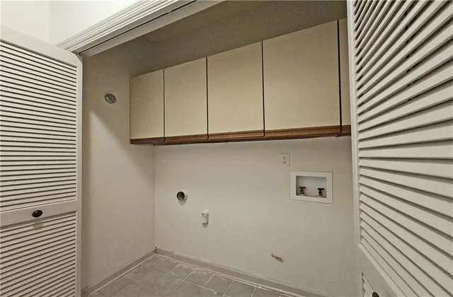 a view of a refrigerator a sink and cabinets