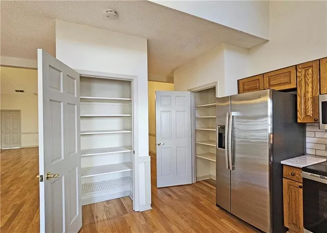 a view of walk in closet with empty racks