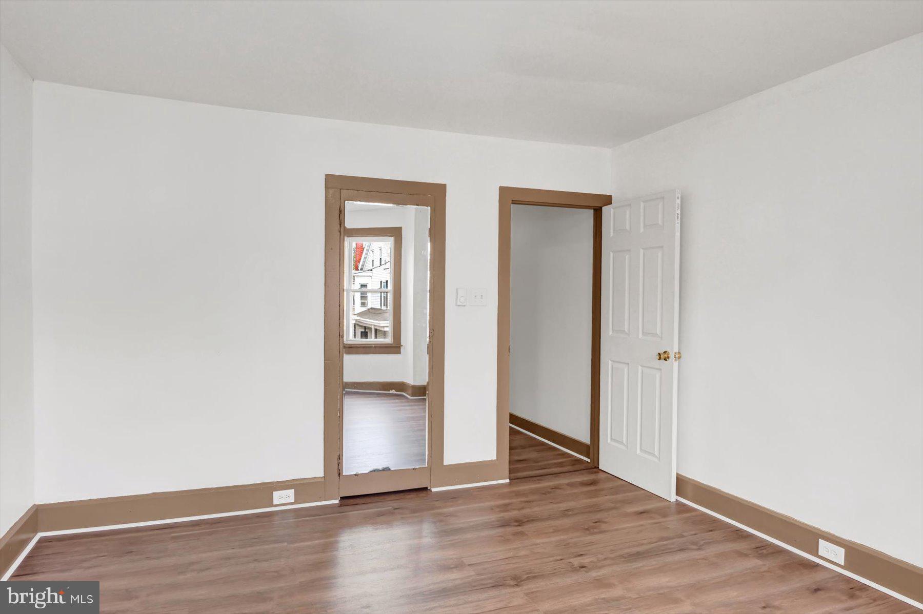 23 North 6th Street Shamokin, PA 17872 - Photo 12 of 27 an empty room with wooden floor and closet