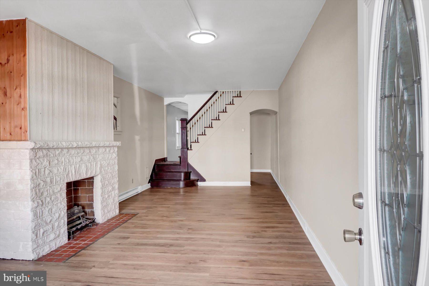23 North 6th Street Shamokin, PA 17872 - Photo 6 of 27 a view of empty room with wooden floor and fireplace
