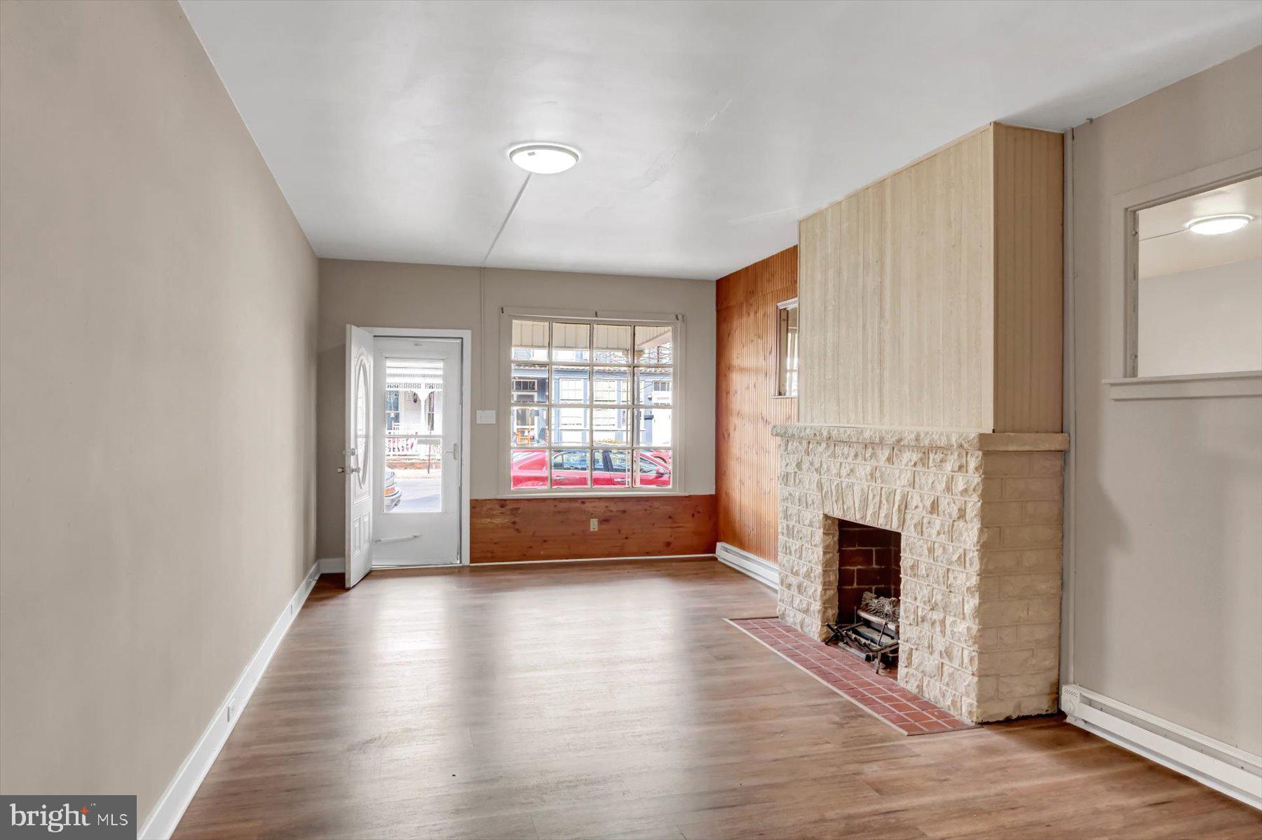 23 North 6th Street Shamokin, PA 17872 - Photo 7 of 27 a view of empty room with fireplace and wooden floor