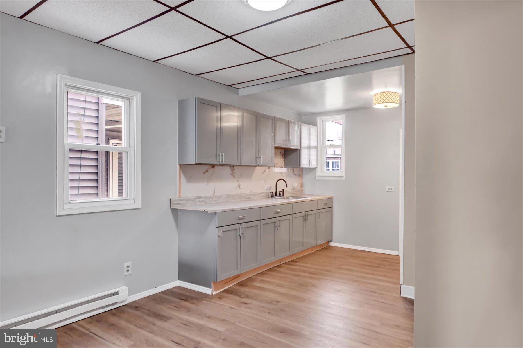 23 North 6th Street Shamokin, PA 17872 - Photo 8 of 27 a kitchen with stainless steel appliances granite countertop a sink a stove a refrigerator and island with wooden floor