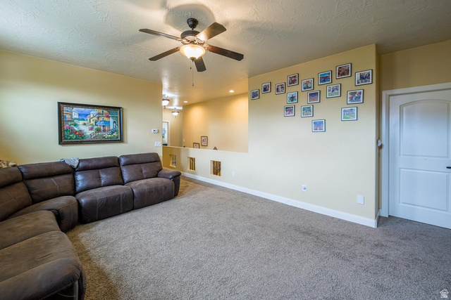 3683 South 2640 West St. George, UT 84790 - Photo 41 of 41 Spacious room featuring textured carpeting, a ceiling fan with integrated lighting, and a white interior door with a black handle