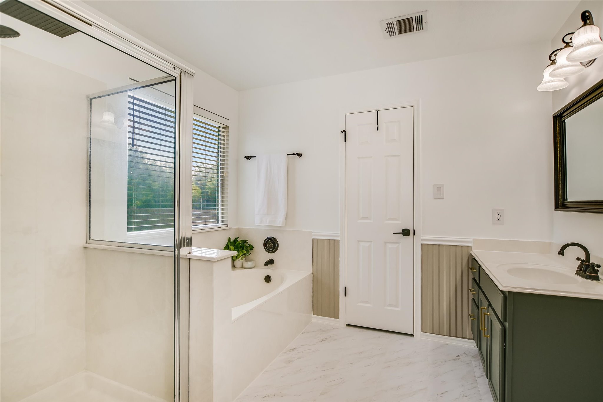 1302 Redbud Lane Leander, TX 78641 - Photo 14 of 28 a bathroom with a tub sink and mirror