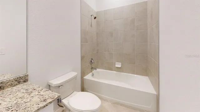 a bathroom with a sink a toilet and bathtub