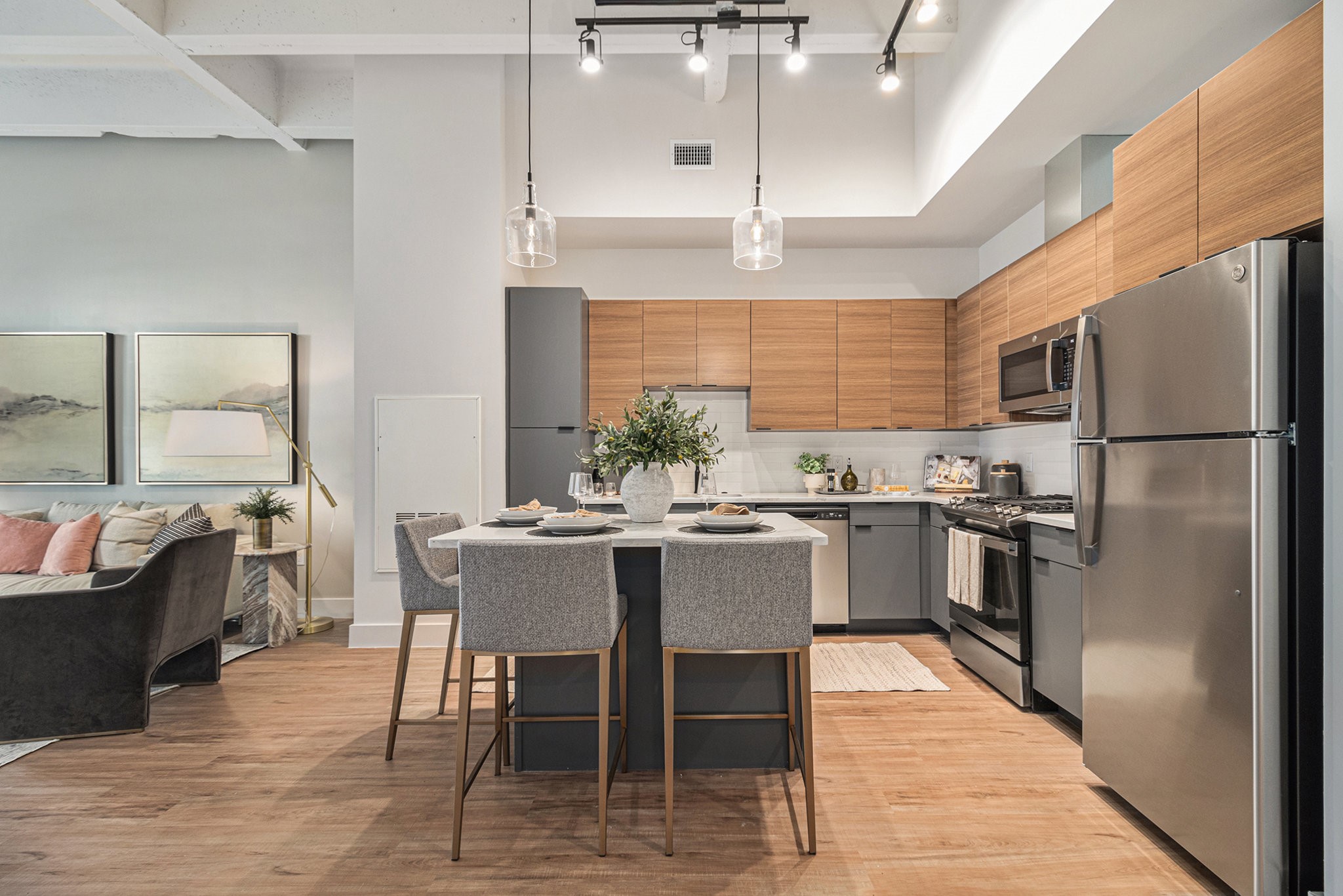 1801 Smith Street, Unit 1701 Houston, TX 77002 - Photo 5 of 25 a kitchen with stainless steel appliances a dining table chairs stove refrigerator and cabinets