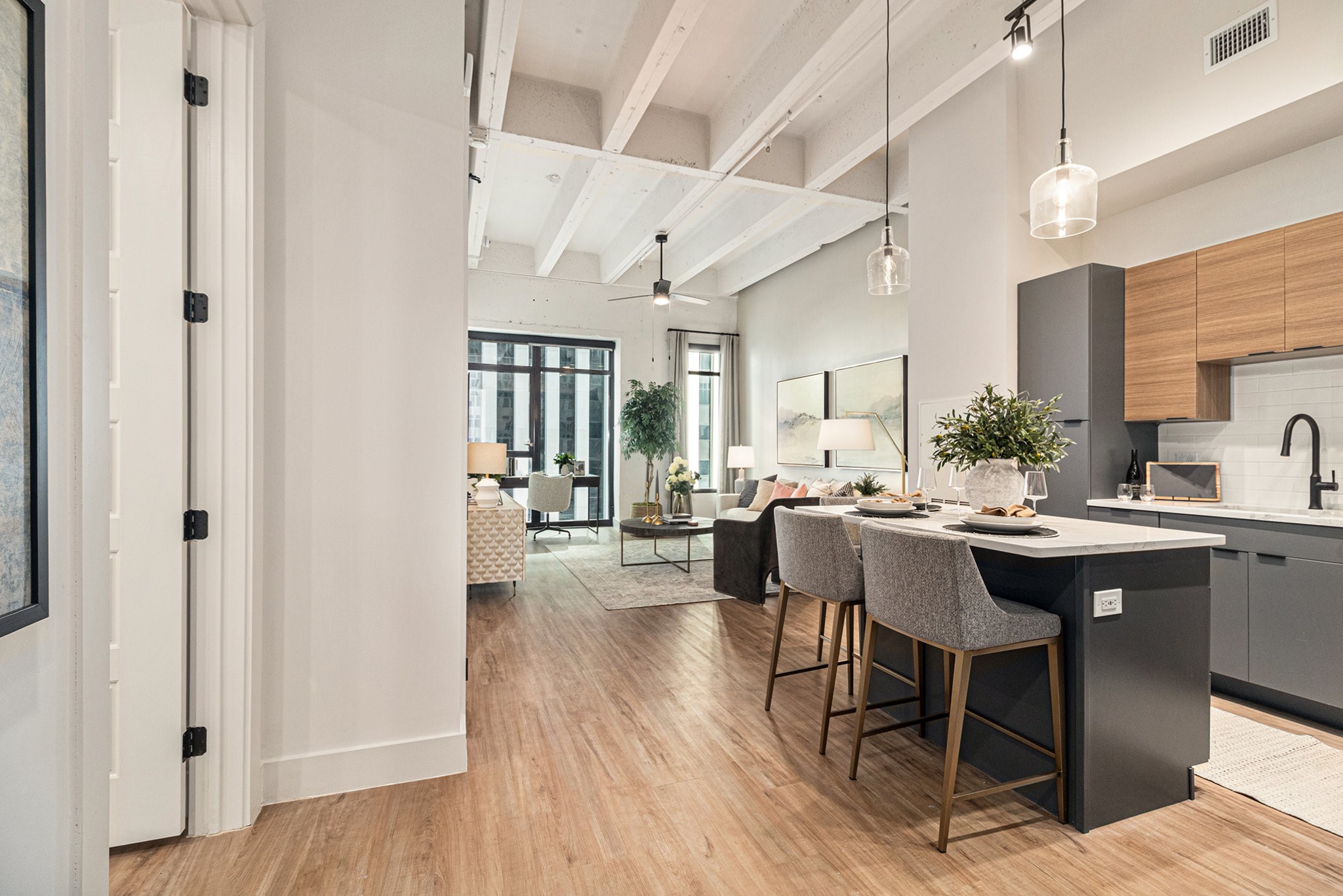 1801 Smith Street, Unit 1701 Houston, TX 77002 - Photo 6 of 25 a dining hall with stainless steel appliances kitchen island a table chairs and a refrigerator