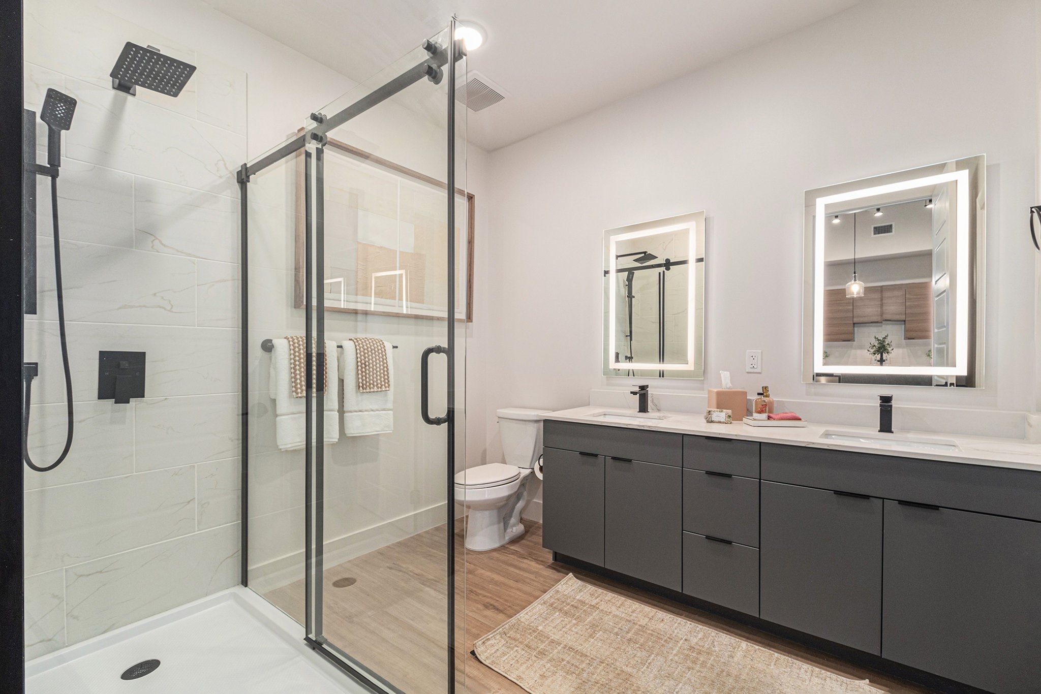 1801 Smith Street, Unit 1701 Houston, TX 77002 - Photo 7 of 25 a bathroom with a double vanity sink mirror and shower