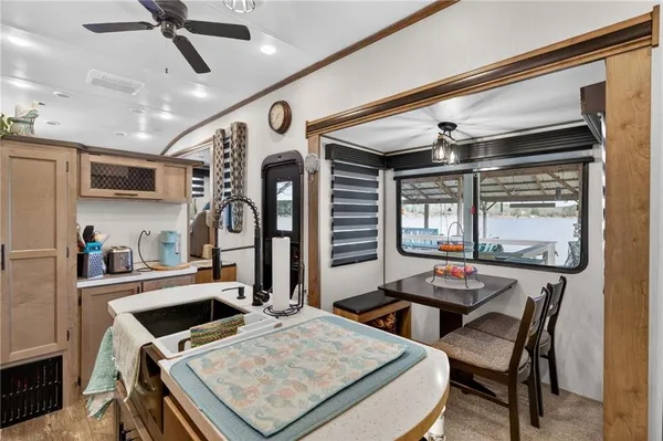 a kitchen with a stove a refrigerator and a dining table