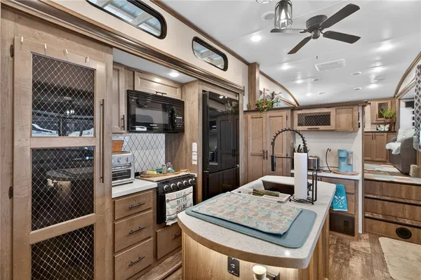 a kitchen with stainless steel appliances granite countertop a sink and cabinets
