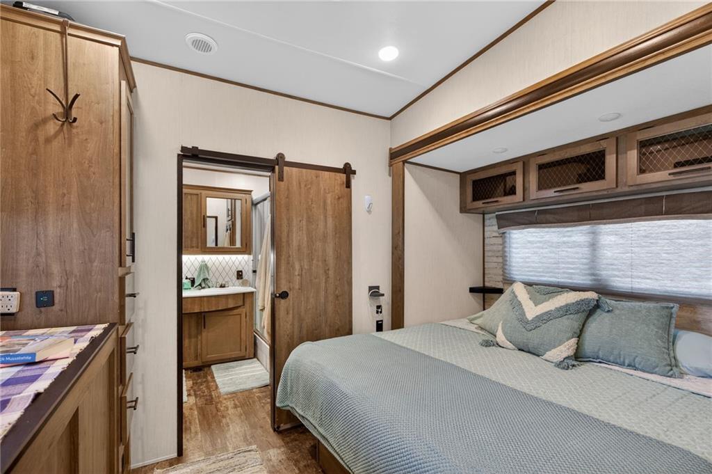 617 County Road 432 Centre, AL 35960 - Photo 16 of 48 a bedroom with a bed and wooden floor