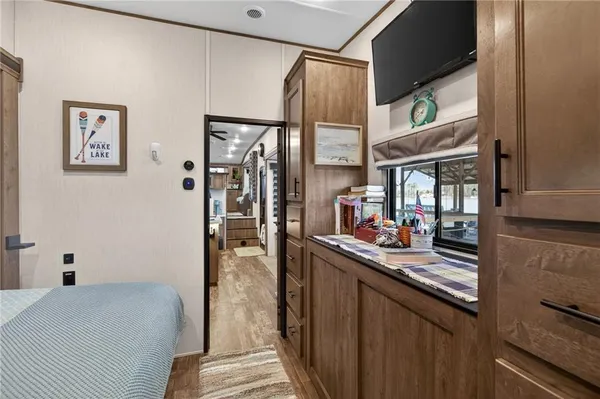 a bedroom with a bed and a refrigerator