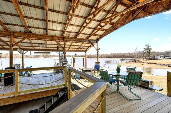 a view of a balcony with chairs and wooden floor