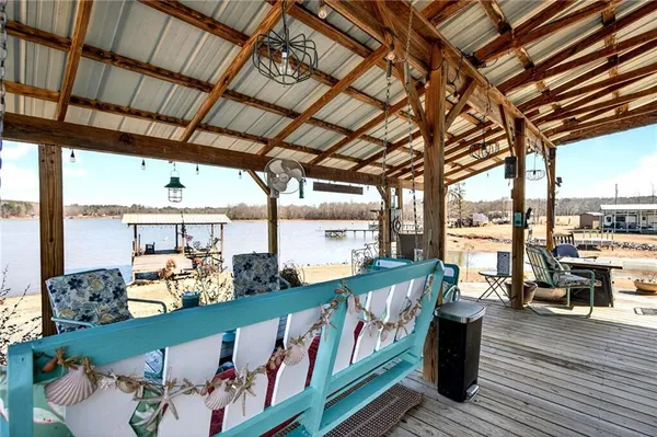 a roof deck with couch and wooden floor