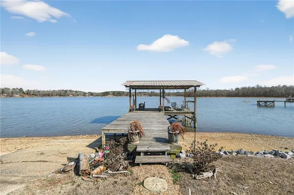 a view of a lake with a table and chairs