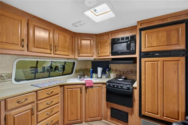 a kitchen with stainless steel appliances granite countertop a stove and a microwave