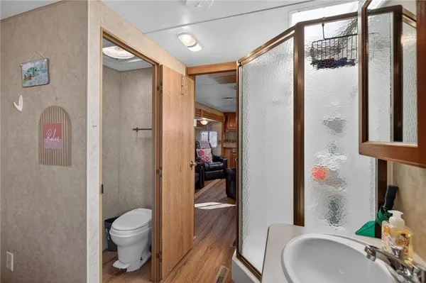 a bathroom with a sink toilet and shower