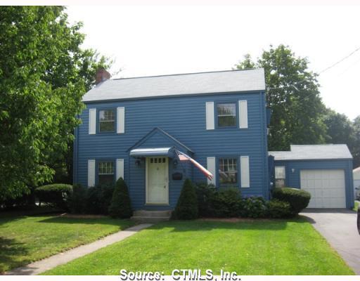 63 Coleman Road Wethersfield, CT 06109 - Photo 1 of 1 a front view of a house with a yard and trees
