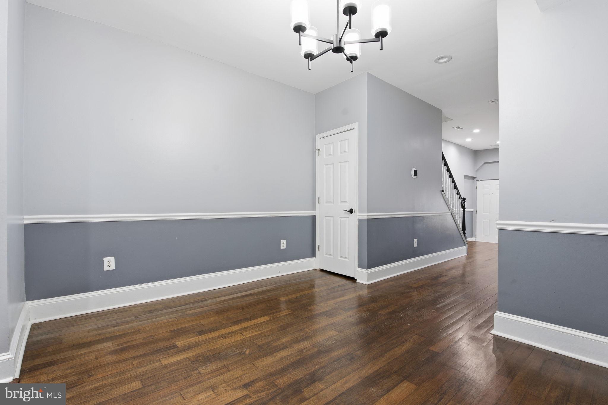 1806 East Lafayette Avenue Baltimore, MD 21213 - Photo 5 of 33 a view of an empty room with wooden floor and a ceiling fan