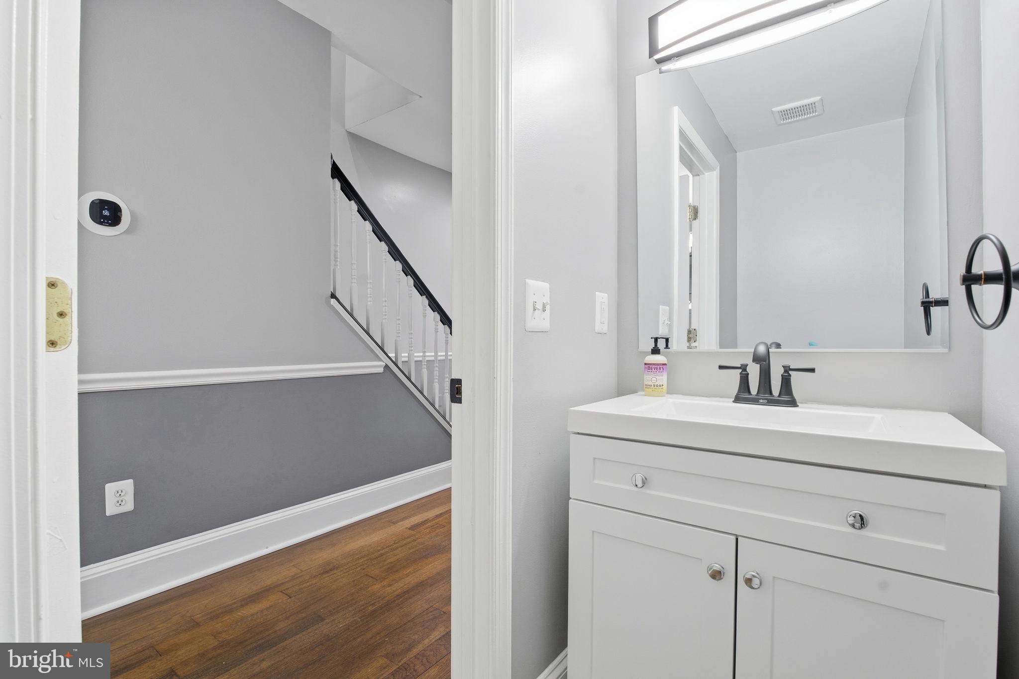 1806 East Lafayette Avenue Baltimore, MD 21213 - Photo 6 of 33 a bathroom with a sink and a mirror