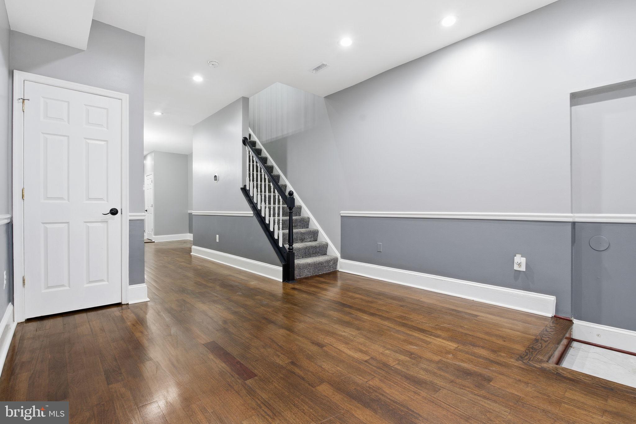 1806 East Lafayette Avenue Baltimore, MD 21213 - Photo 7 of 33 an empty room with wooden floor and windows